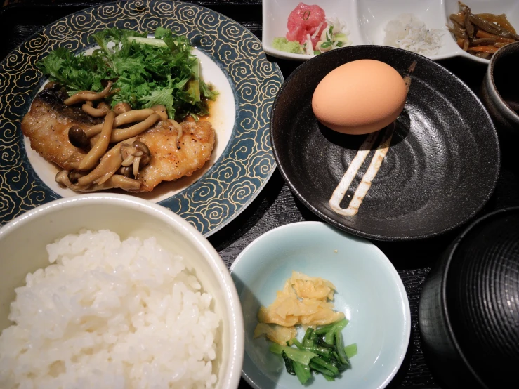 a variety of food with meat, rice, and vegetables