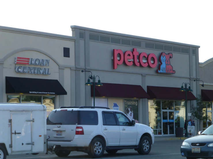 cars parked in front of a petco store