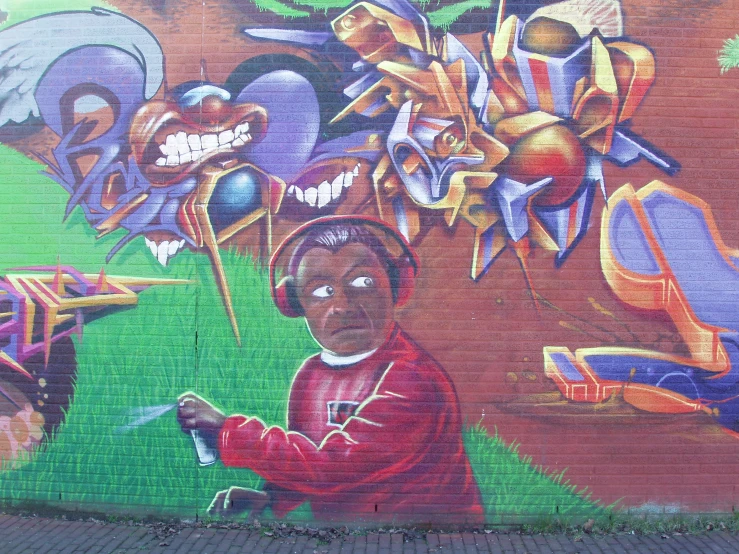 painting of a child holding a paint roller next to a large brick wall with different objects in it