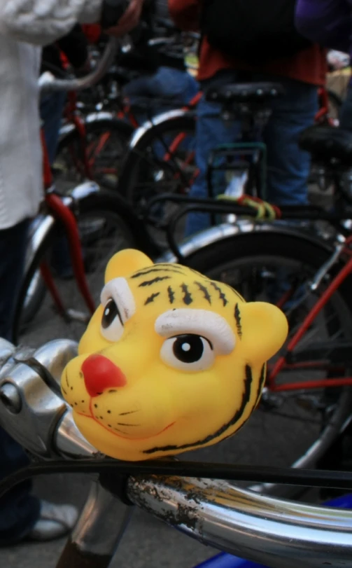 a fake tiger is sticking out of the side of a bicycle