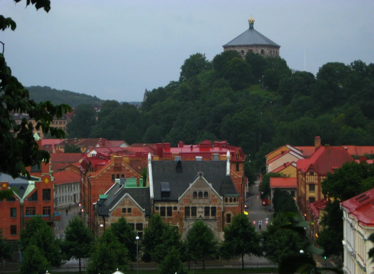 a city is shown at twilight and on a hill