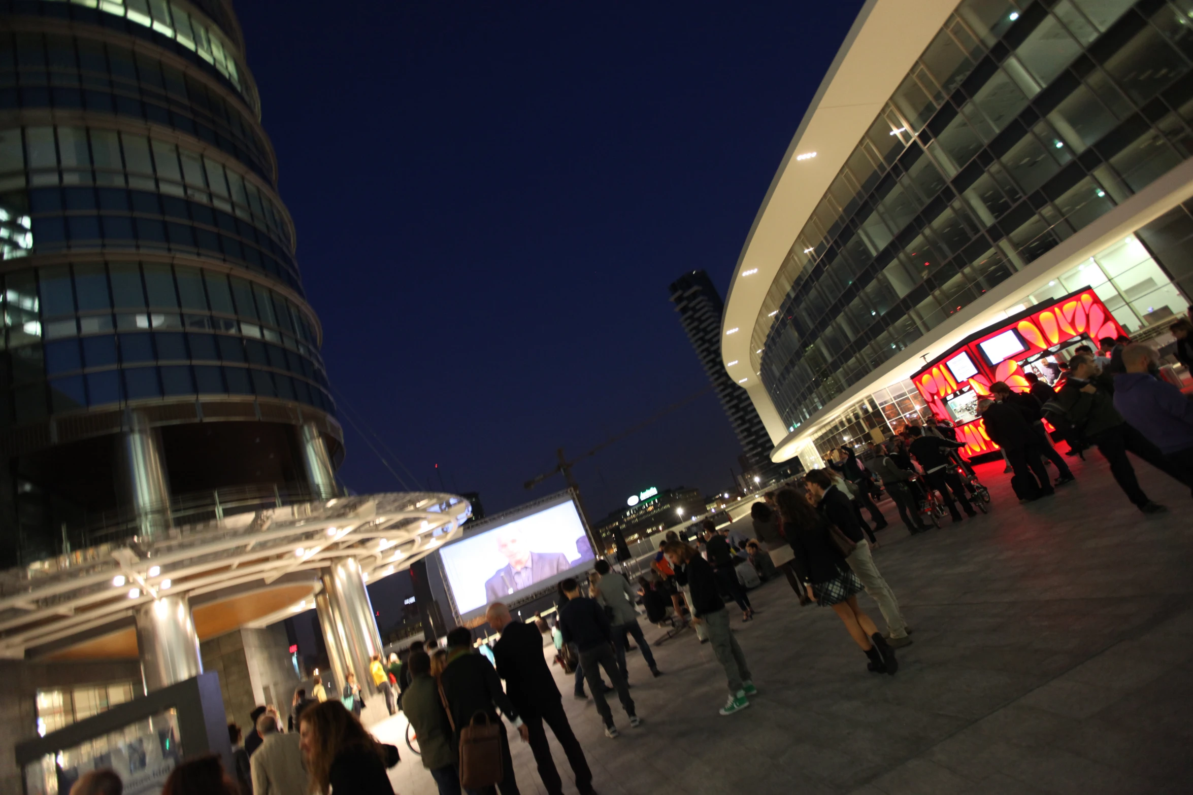 the night is busy and people are outside a business building