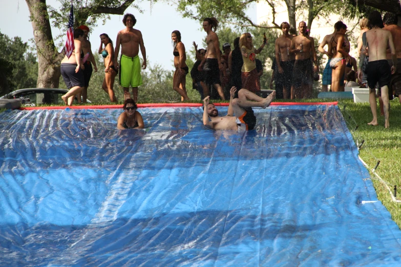 a couple of men that are standing in a pool