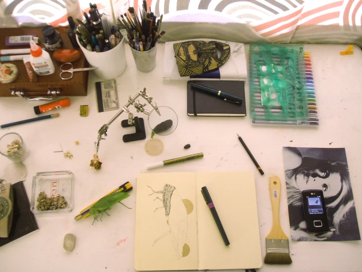 a lot of art supplies on a white surface
