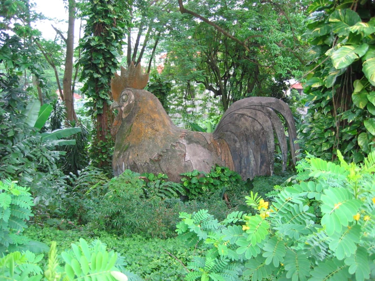 a couple of sculptures sitting on top of a lush green forest