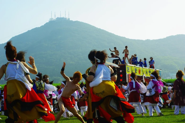 women in traditional costume are dancing in front of a crowd