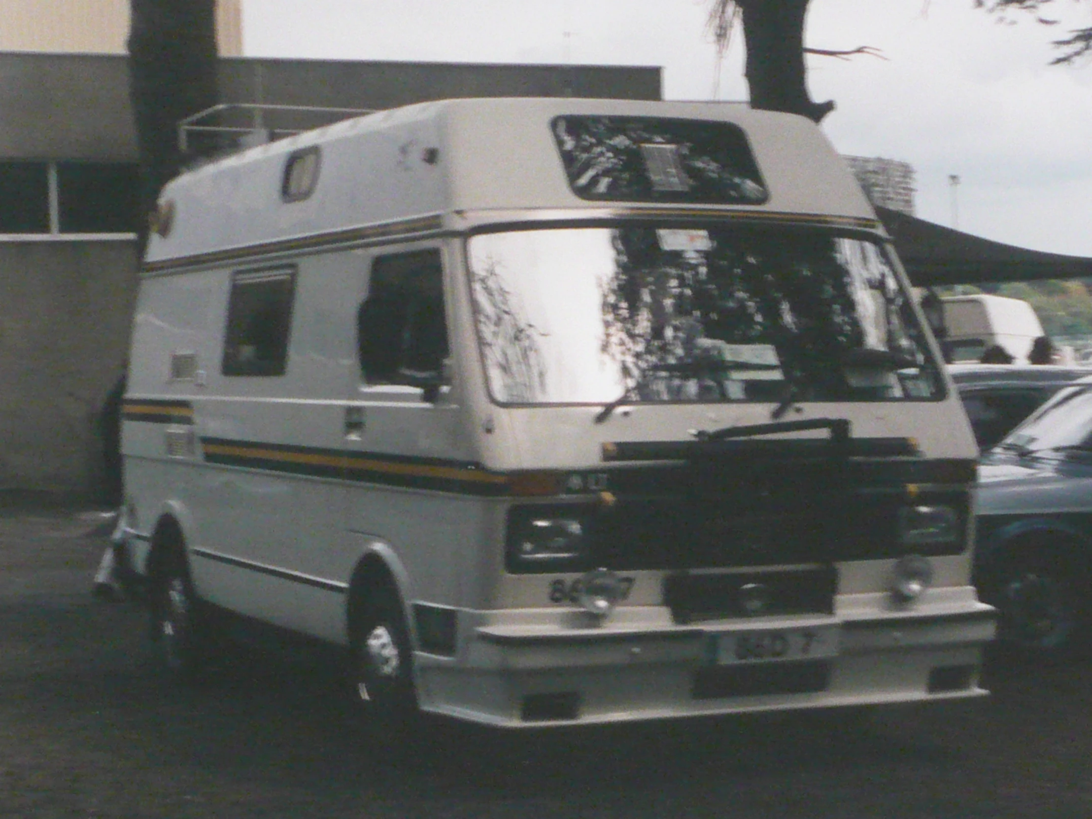 a white bus parked next to a building