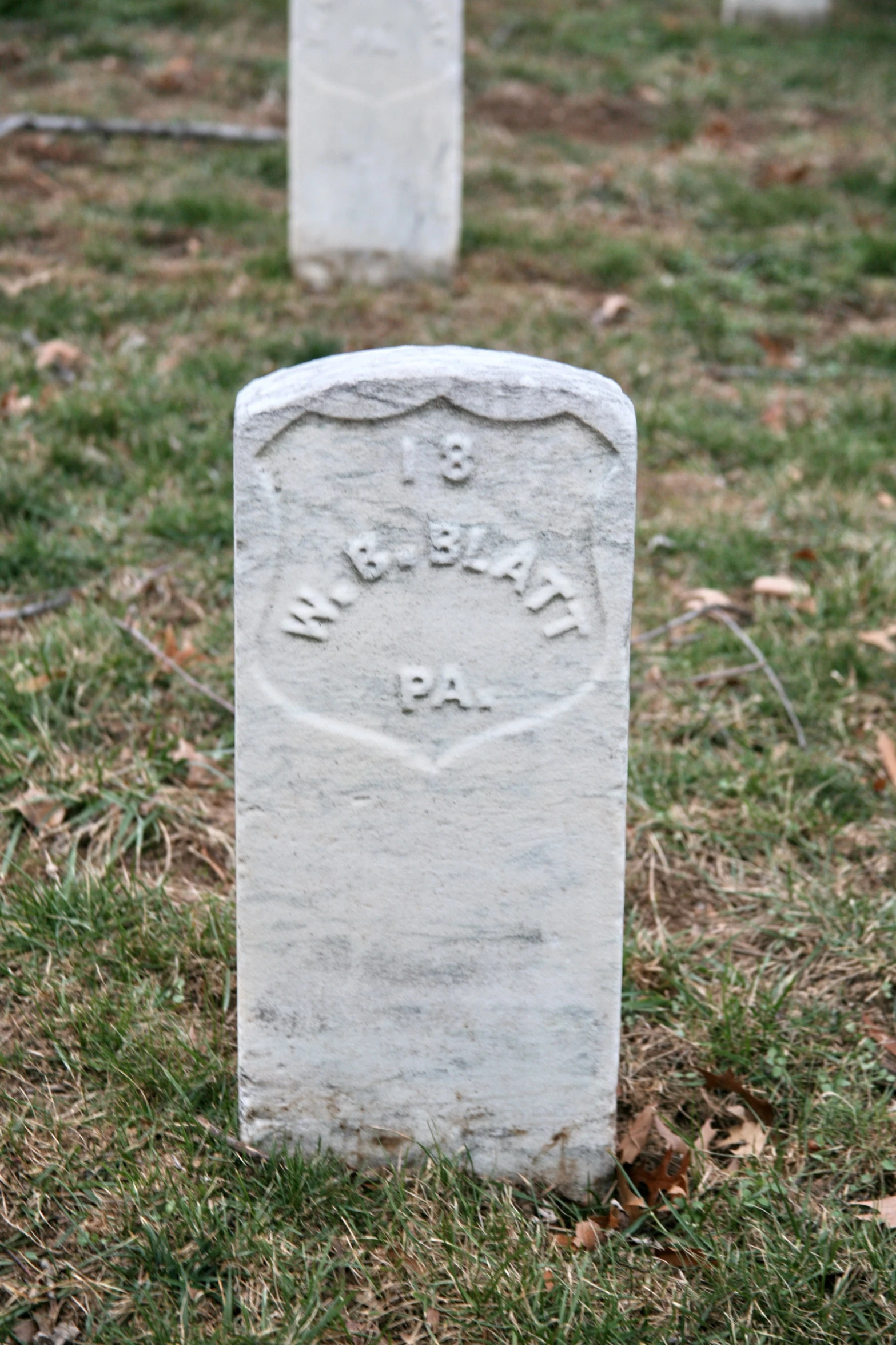 there are two headstones in the grass