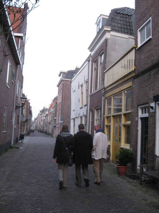 two men walking on a street in an old european city