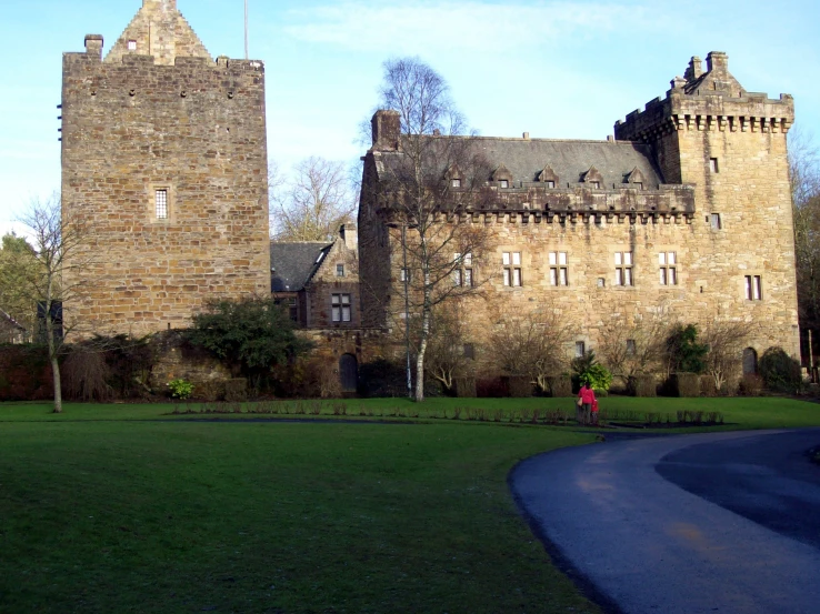 a beautiful large stone castle like building on a sunny day