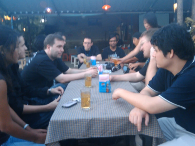 people sitting at a table looking up to the sky