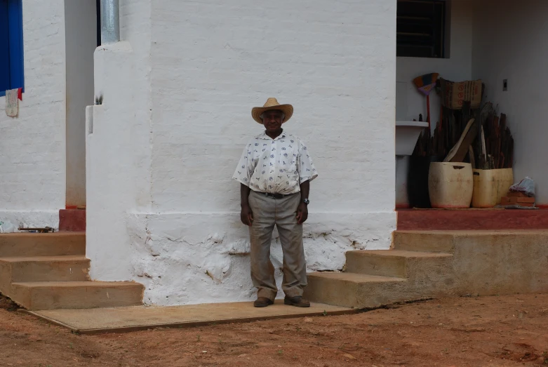 a man standing at the steps of a house