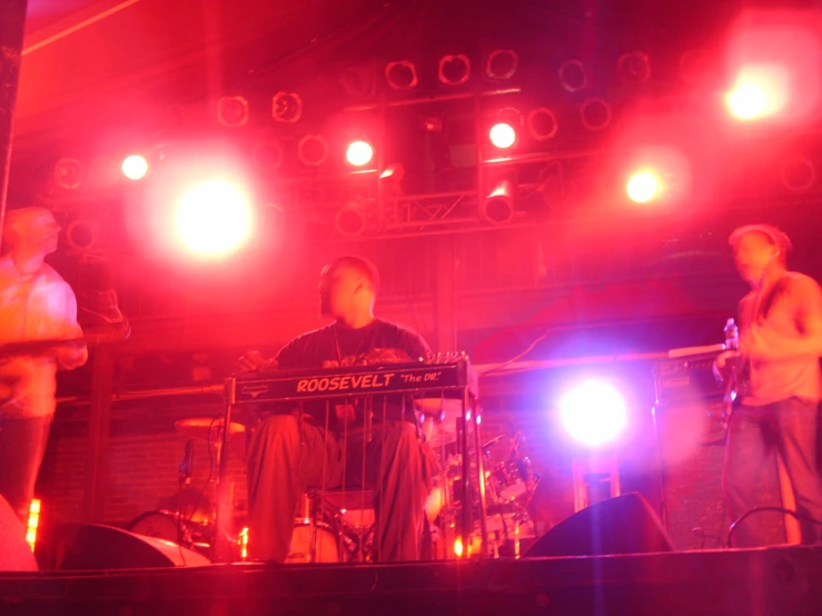 some people on stage with colorful lighting