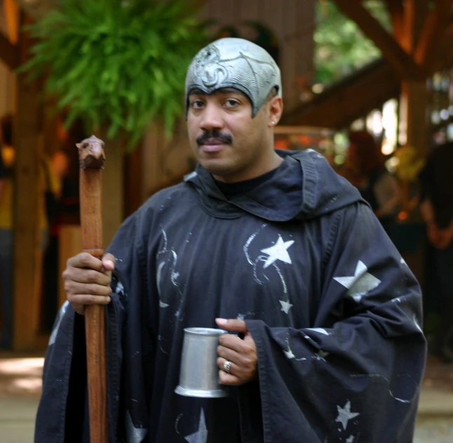 the man in costume holds onto a coffee cup