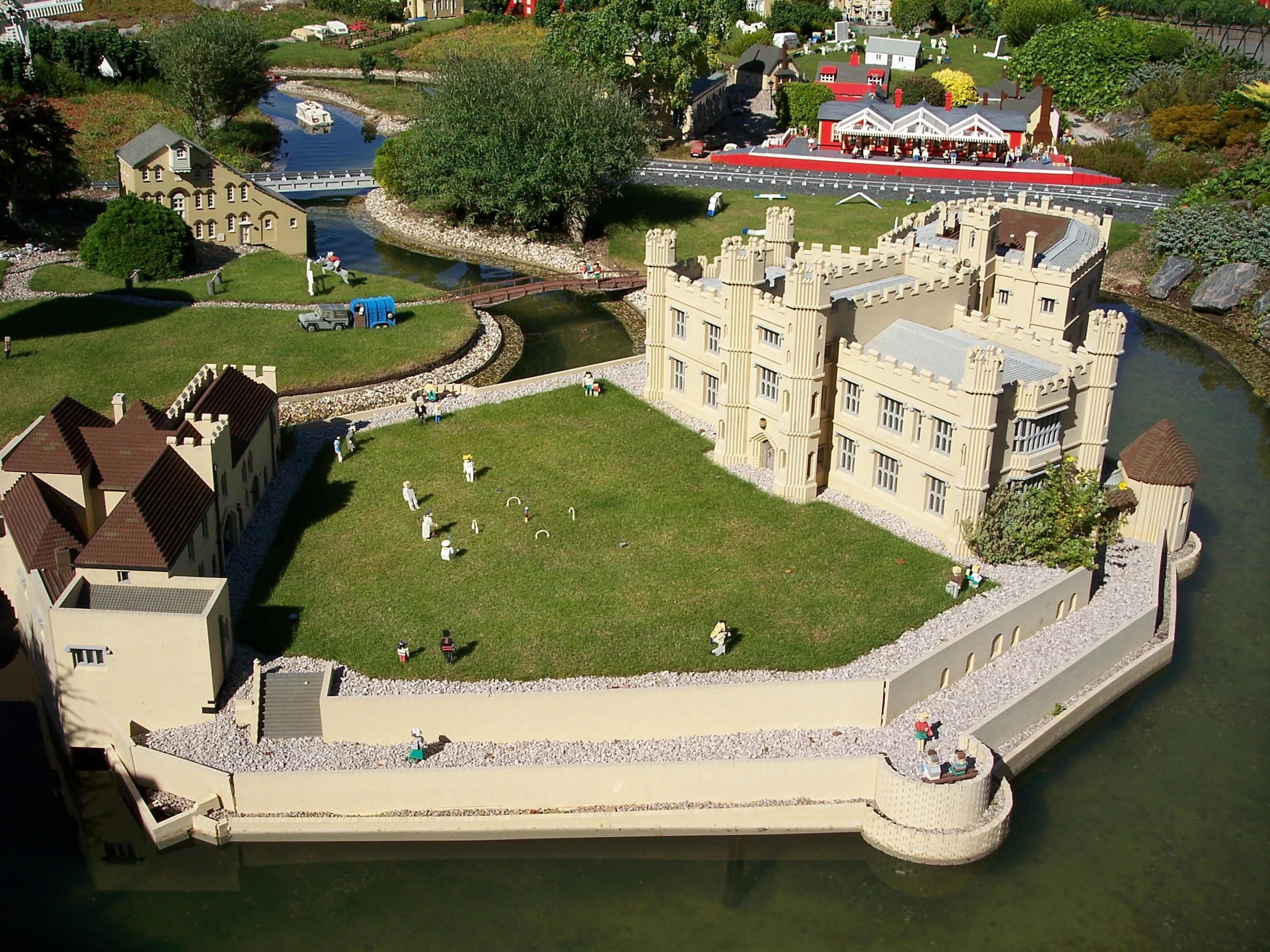 a castle like structure sitting next to a river