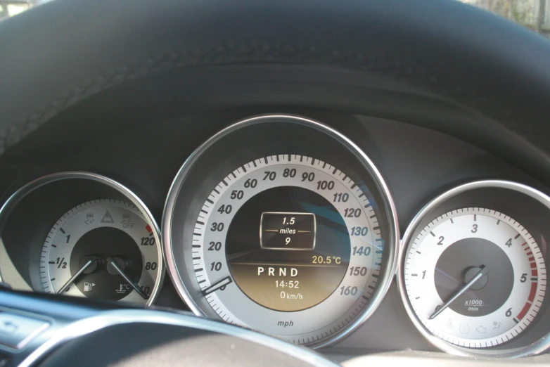 closeup of gauges in car on sunny day