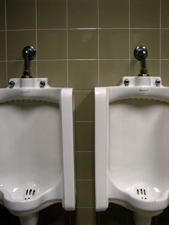 two urinals side by side with no curtains