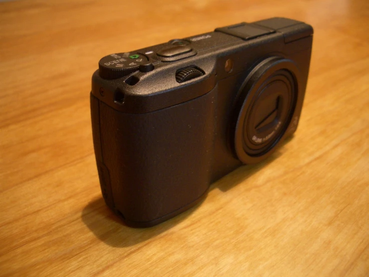 a digital camera sitting on a wooden table