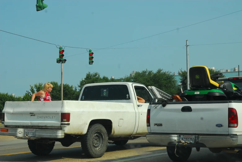 the pick up truck is on the road by the stoplight