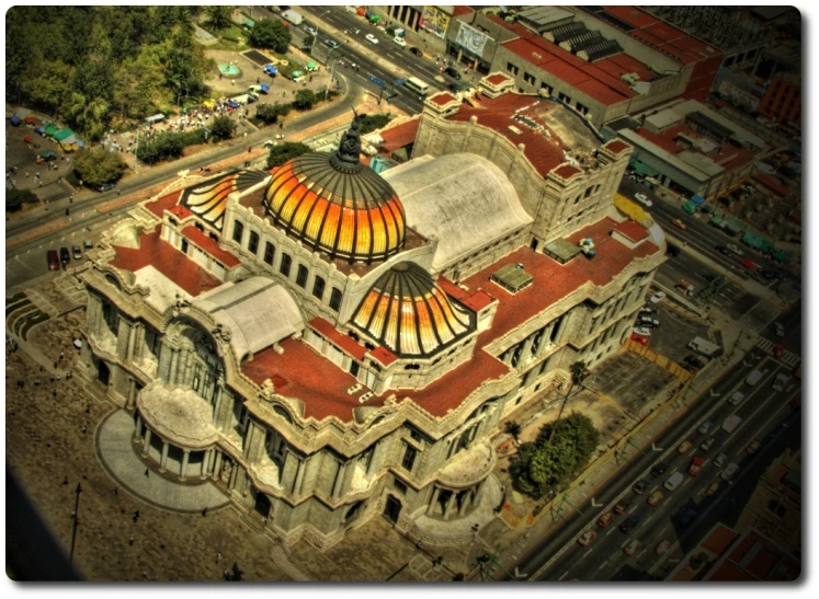 an aerial view of a building with two domes