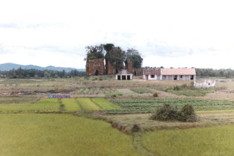 a farm house sitting on top of a lush green field