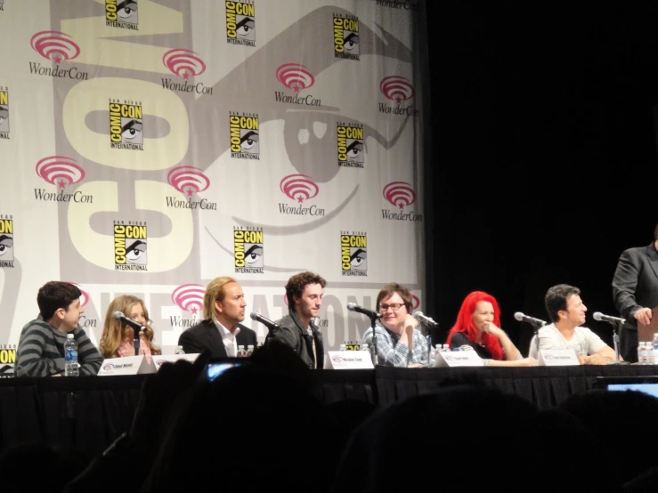 many people sitting around a table at a convention