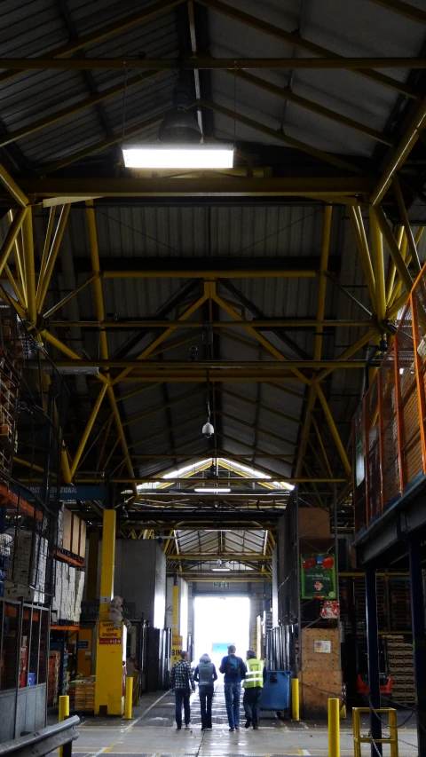 people walking around an indoor storage unit