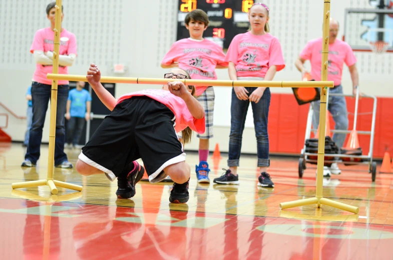 a  playing on the gym with her teammates