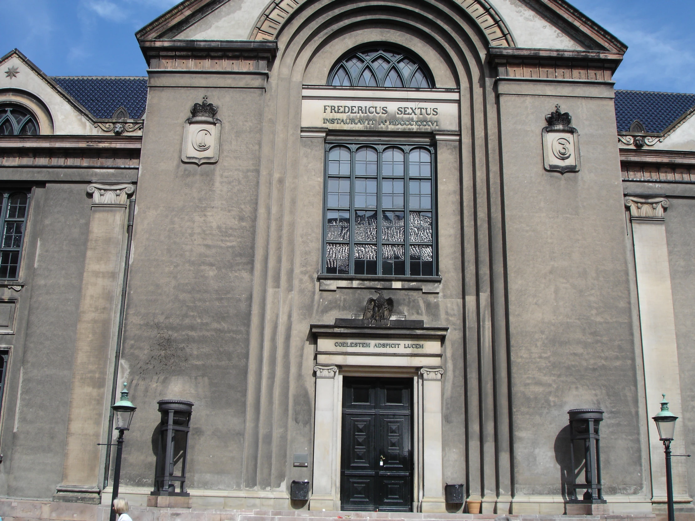 the building has windows and a sign above the door