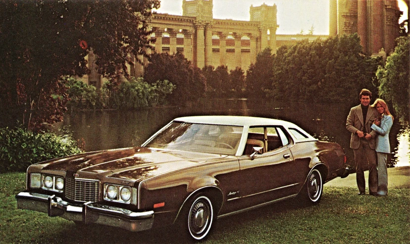 an old car and woman in grassy area near trees