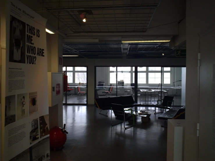 office with chairs and a desk in front of big windows