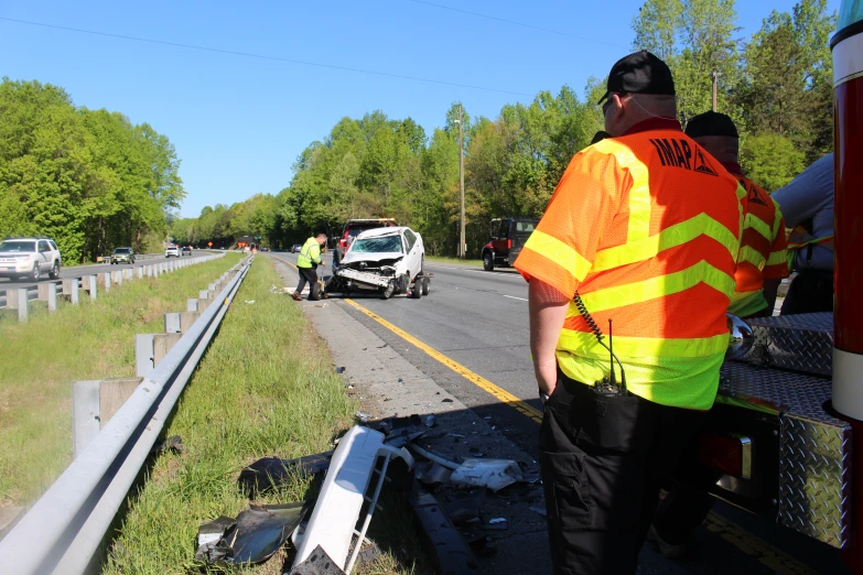 a traffic cop checks on an overturned car after a serious crash