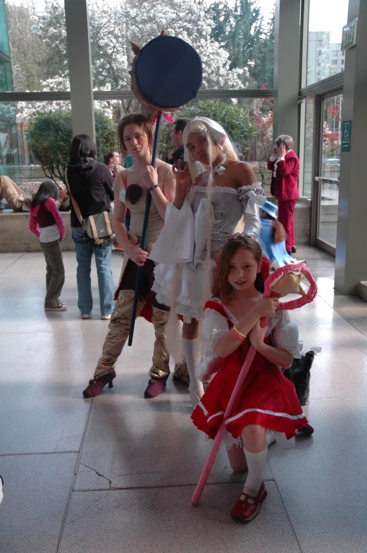 two girls dressed as zombies with people posing behind them