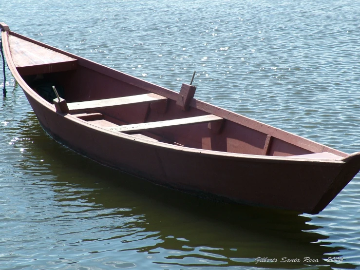 a row boat with one oar is empty on a lake