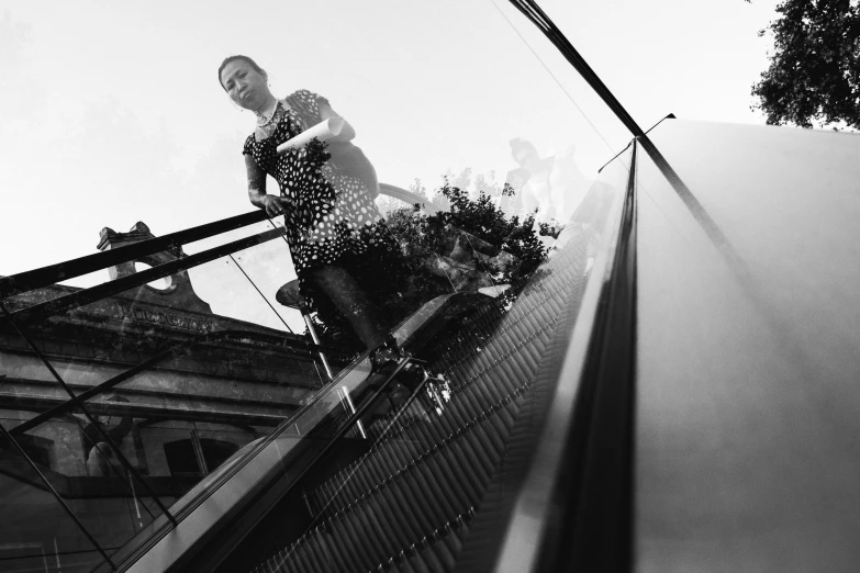 a person riding a skateboard down an escalator