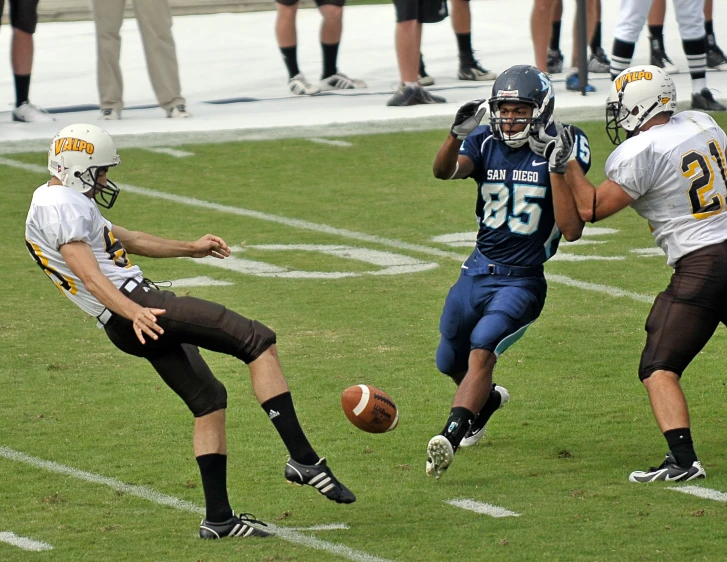 football players are running after the ball and kicking it