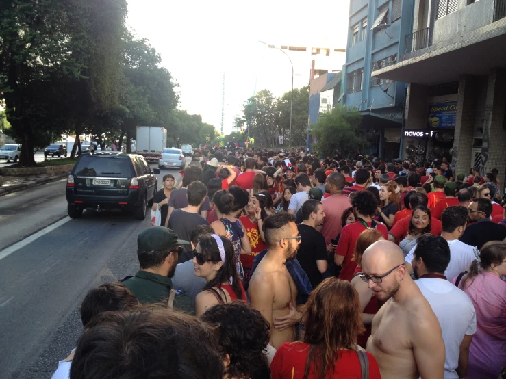 a large group of people marching on the street