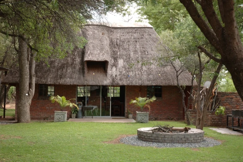 an open area with a thatched roof house