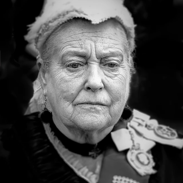 an old woman wearing black and white attire