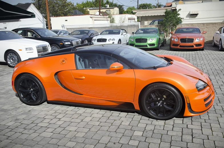 there is an orange sports car parked in the street