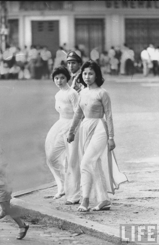 a group of women walking down the street together