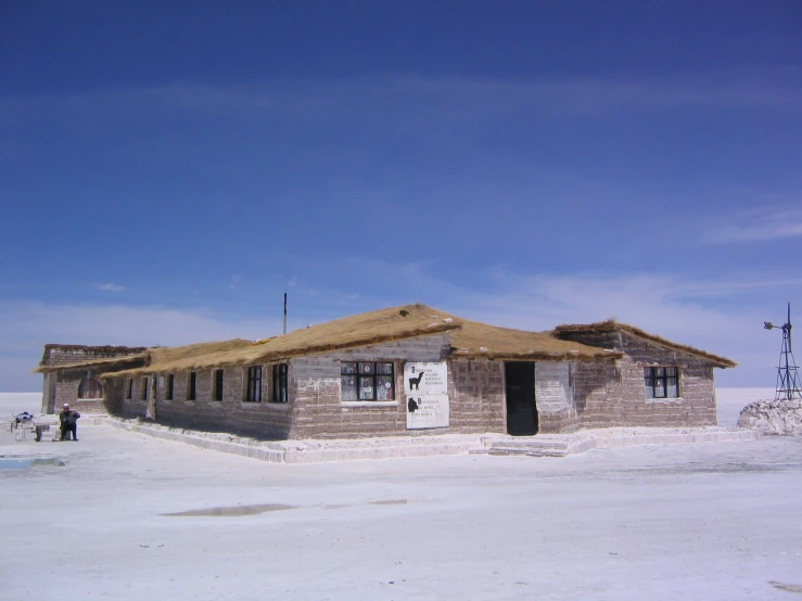 the front side of a shack is seen under a blue sky