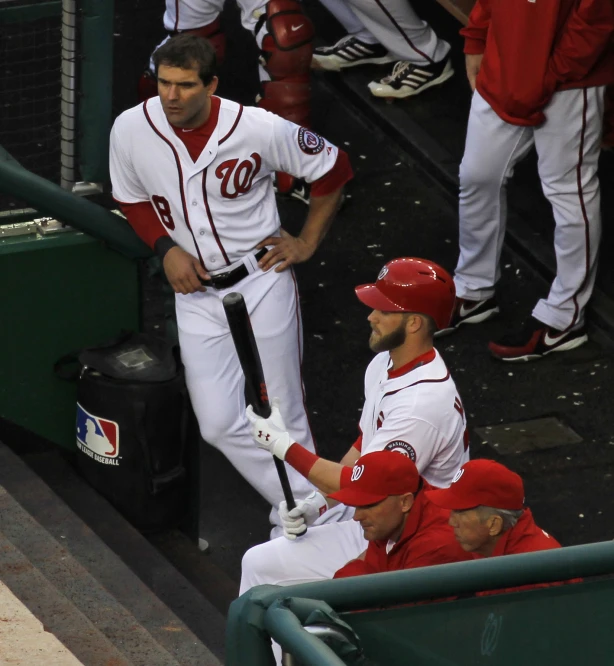 a team of baseball players sitting in the dugout