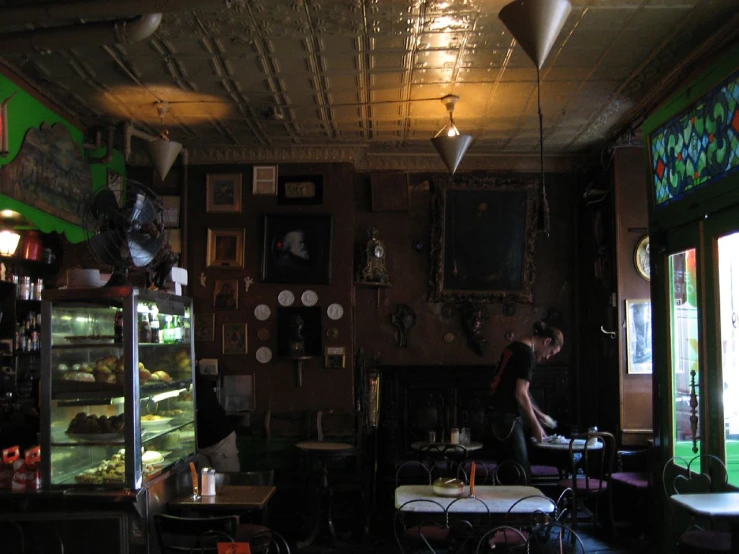 a woman standing in front of a bakery case