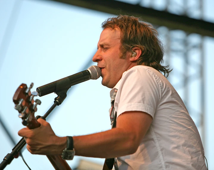 a man is playing a guitar on stage