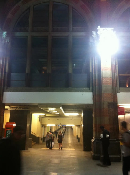 a group of people walking out of a large building