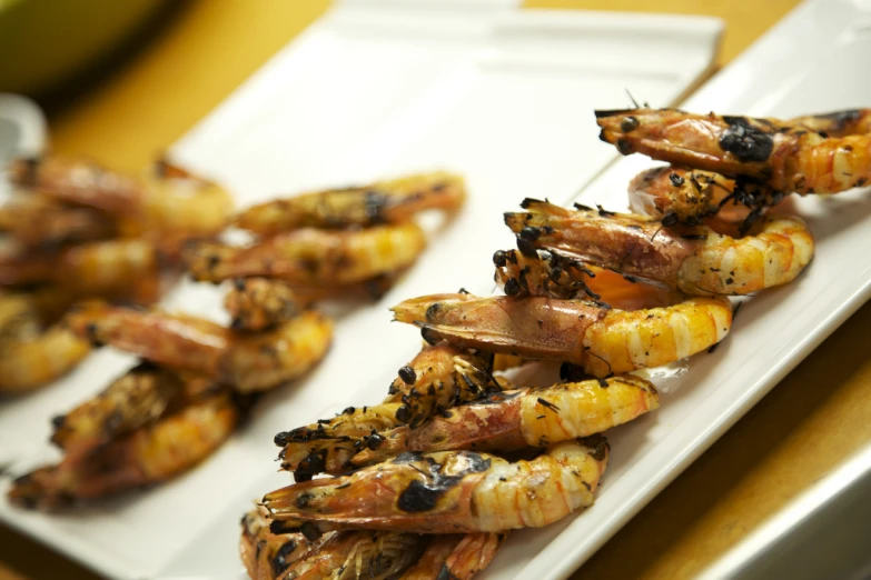 shrimp are grilled on a white plate