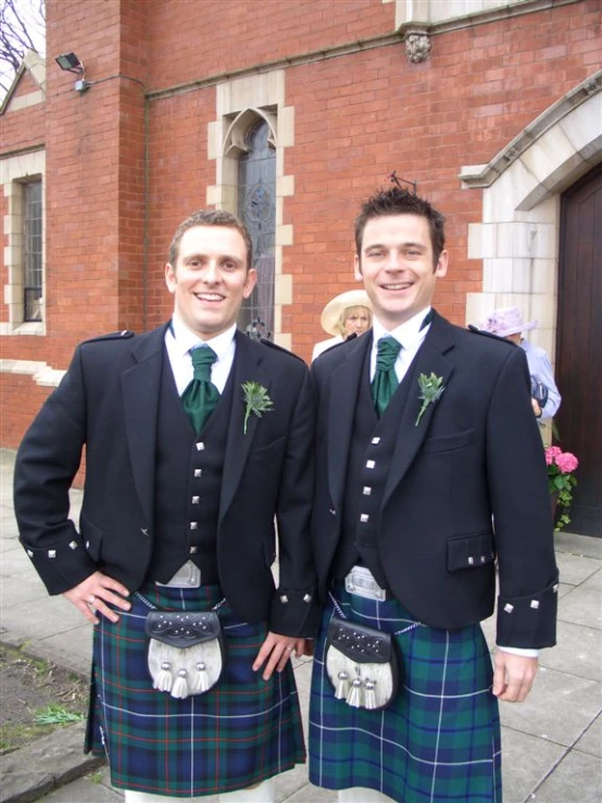 two men dressed in plaid and kilts