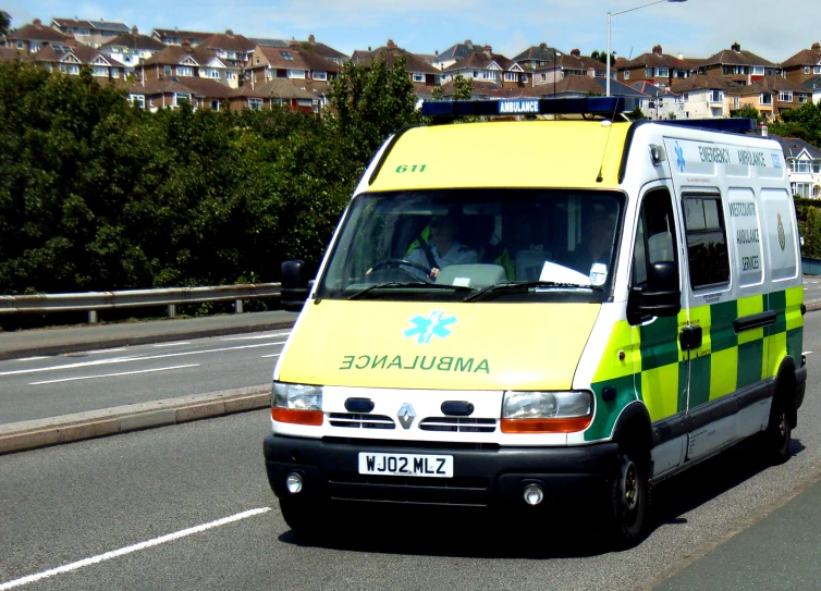 an ambulance truck is driving down the street