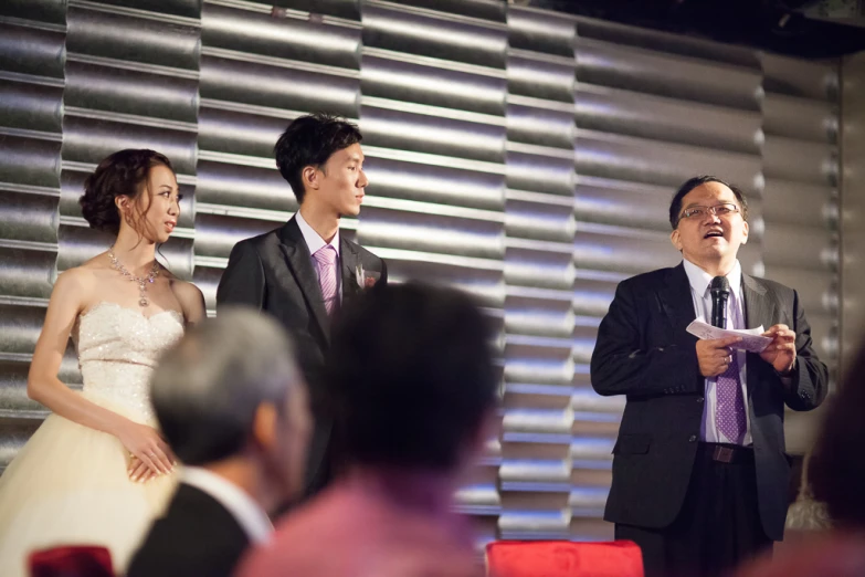 an asian man and woman during wedding ceremony